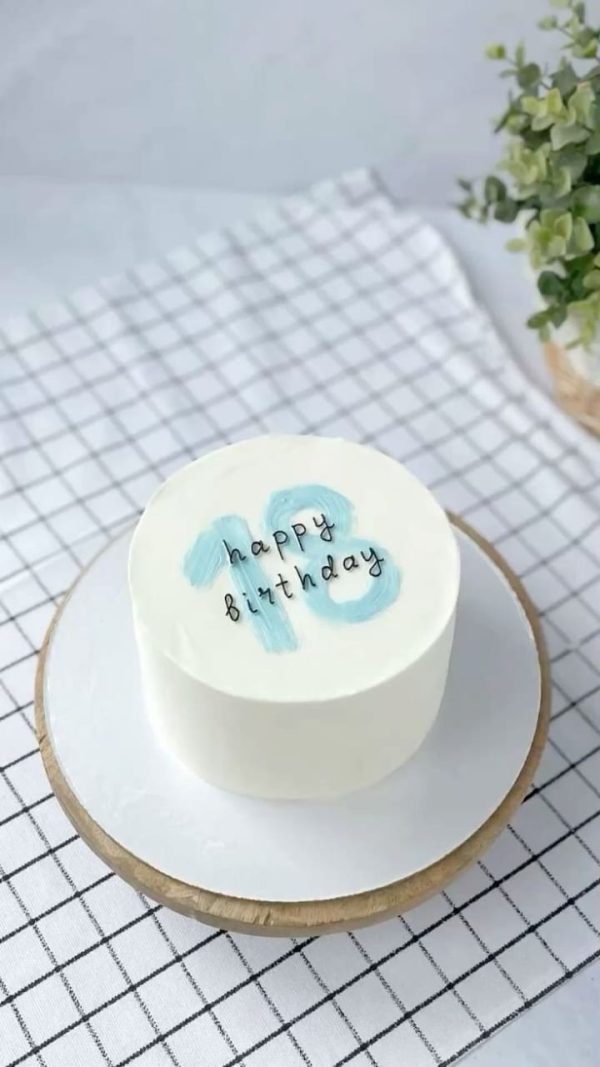 Minimalist aesthetic cake with blue brushstroke number “13” and handwritten “happy birthday” text