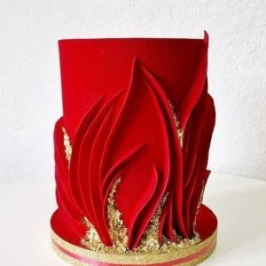 Red fondant cake with flame-like decorations and gold accents – Ruby Gold Cake